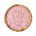 Small pink rose quartz chips in a round dish