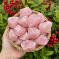 Rough pink rose quartz chunks in a dish