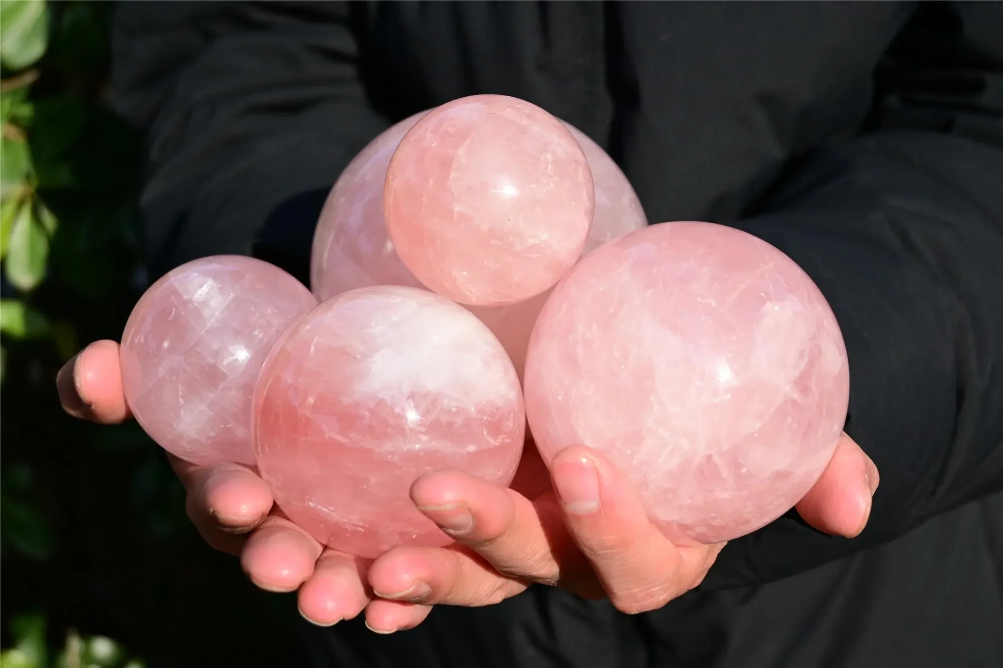 Polished rose quartz spheres in different sizes