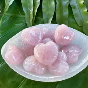Pink rose quartz heart stones in a bowl