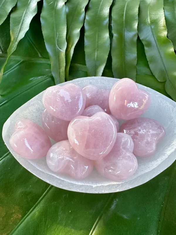Pink rose quartz heart stones in a bowl Pink rose quartz heart stones in a bowl